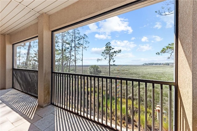 sunroom featuring a rural view