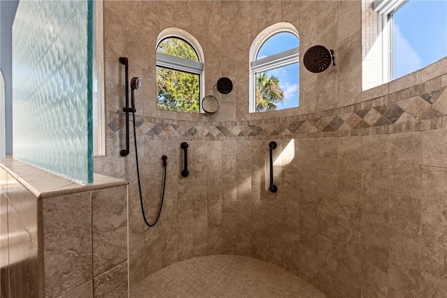 bathroom with tiled shower