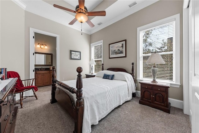 carpeted bedroom with crown molding, ceiling fan, and ensuite bathroom