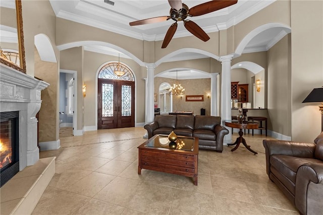 living room with ornate columns, crown molding, and a high ceiling