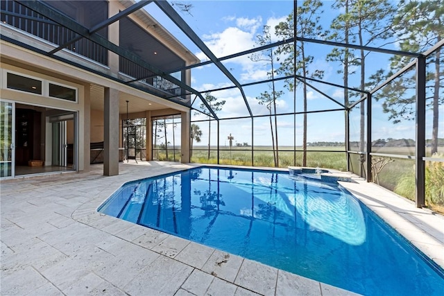 view of swimming pool with a patio, an in ground hot tub, and glass enclosure