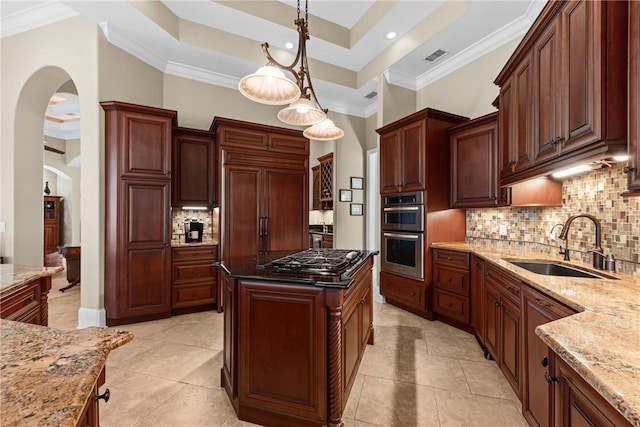 kitchen featuring pendant lighting, sink, light stone countertops, and stainless steel appliances