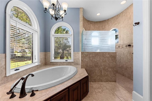 bathroom with separate shower and tub, a chandelier, and tile patterned flooring