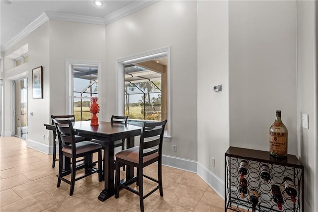 dining room with crown molding and light tile patterned floors