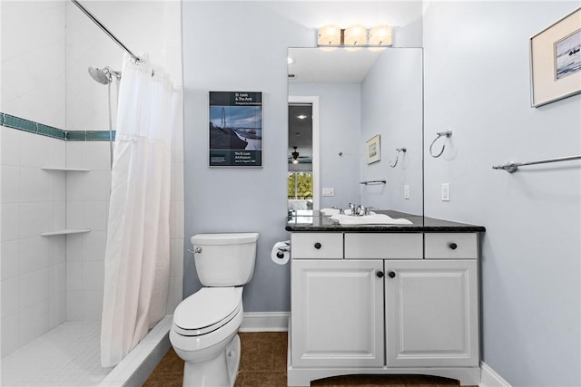 bathroom featuring ceiling fan, vanity, a shower with curtain, tile patterned floors, and toilet