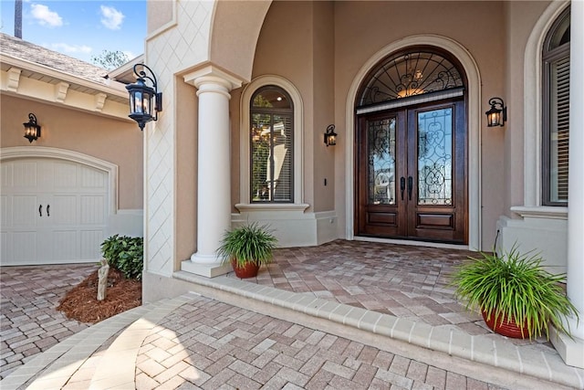 doorway to property featuring a garage and french doors