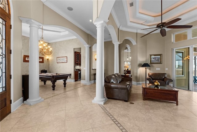 tiled living room with ornate columns, ornamental molding, a raised ceiling, a towering ceiling, and ceiling fan