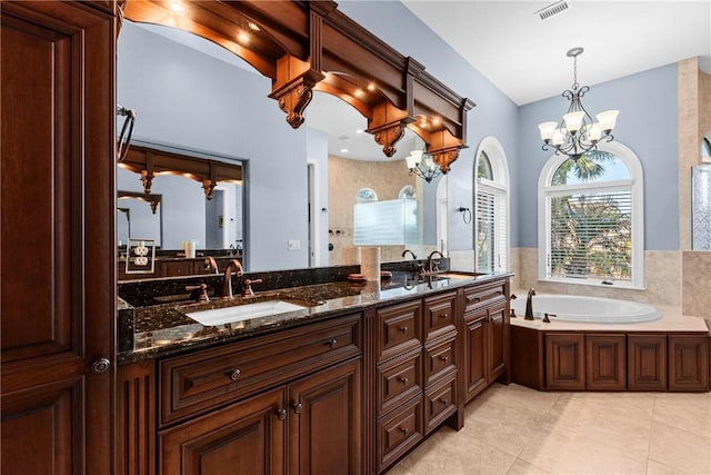 bathroom featuring vanity, a tub to relax in, tile patterned floors, and a chandelier