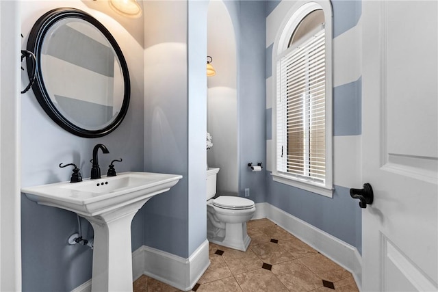 bathroom with tile patterned flooring and toilet