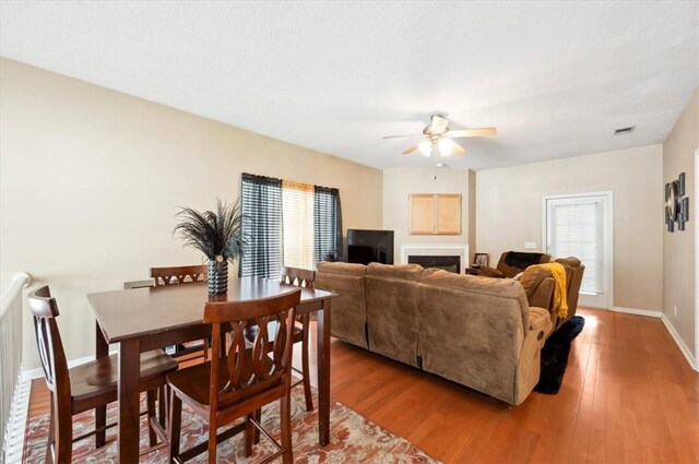 118 Drayton Cir, Brunswick, GA 31525 - dining area with plenty of natural light, a ceiling fan, wood finished floors, and a fireplace