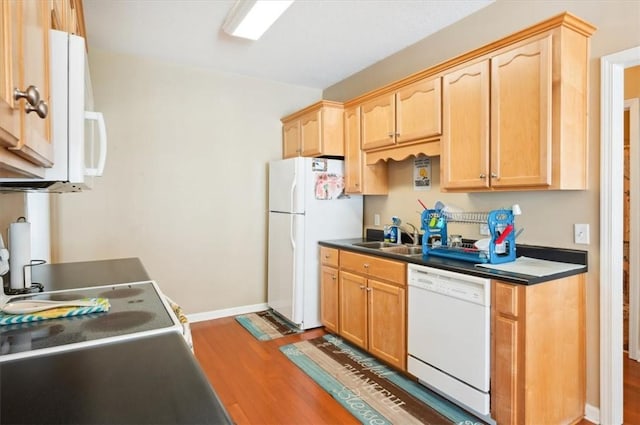 118 Drayton Cir, Brunswick, GA 31525 - kitchen with white appliances, wood finished floors, light brown cabinets, and dark countertops