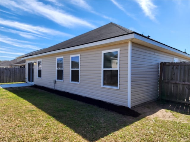 view of property exterior featuring a fenced backyard and a yard