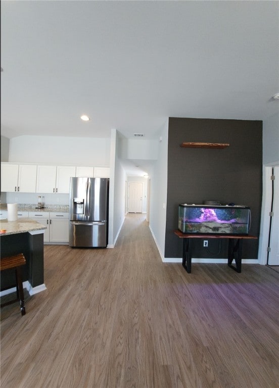 living room with visible vents, recessed lighting, wood finished floors, and baseboards