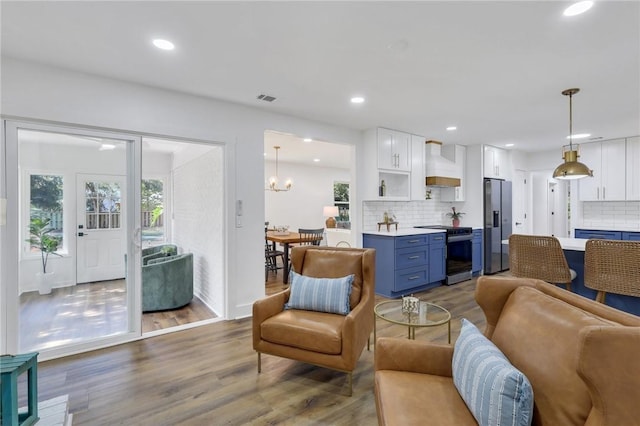 living room featuring hardwood / wood-style floors and a chandelier