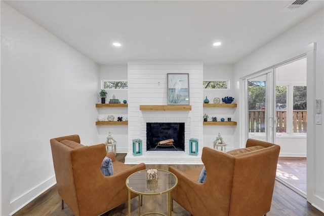 living room with a fireplace and dark hardwood / wood-style floors