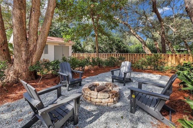 view of patio / terrace featuring an outbuilding and an outdoor fire pit