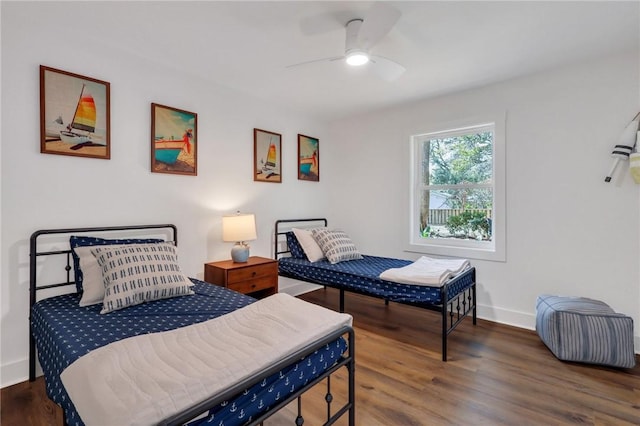 bedroom with ceiling fan and dark hardwood / wood-style flooring