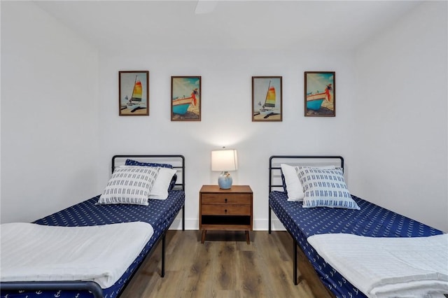 bedroom featuring wood-type flooring and ceiling fan