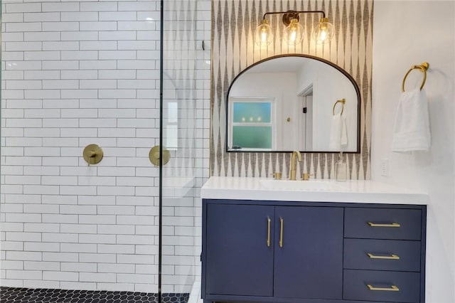 bathroom with vanity and a tile shower