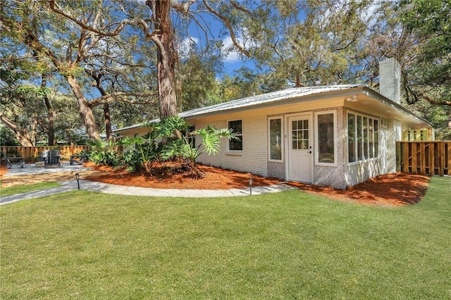 rear view of house with a yard