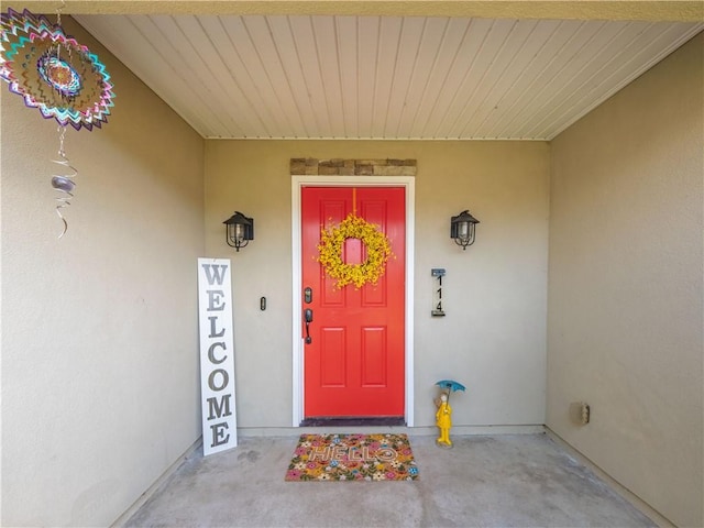 doorway to property with stucco siding