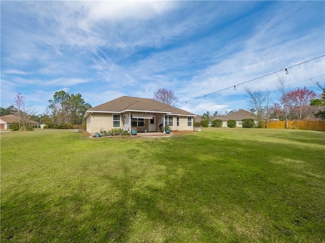 rear view of property with a lawn