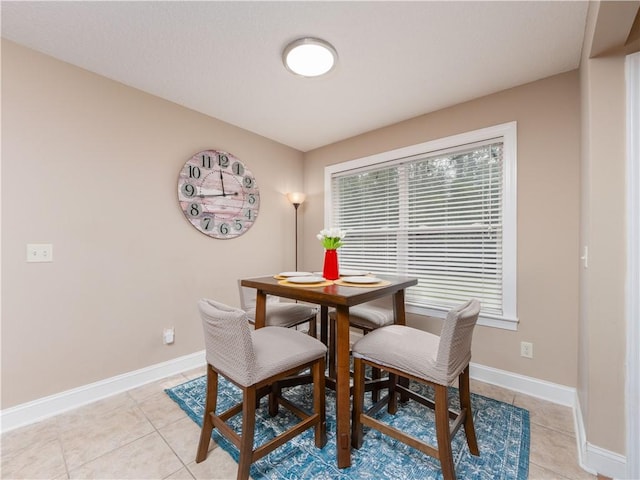 dining area with baseboards and light tile patterned floors