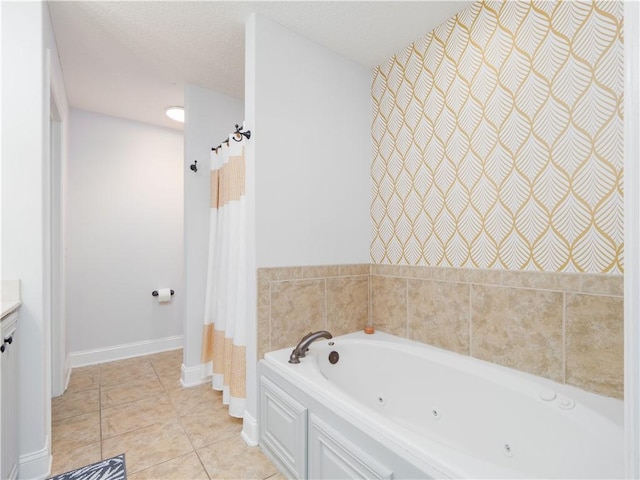 bathroom featuring a whirlpool tub, a textured ceiling, tile patterned flooring, and baseboards