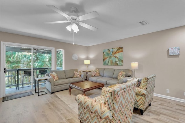 living room featuring light wood-type flooring and ceiling fan