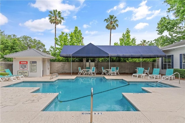 community pool featuring a patio area and fence