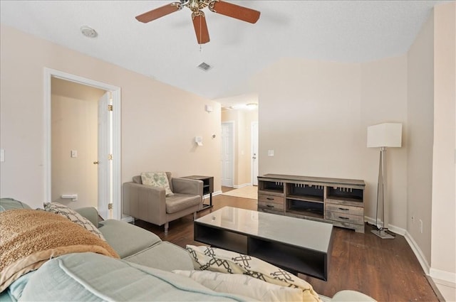 living room with ceiling fan and dark hardwood / wood-style flooring