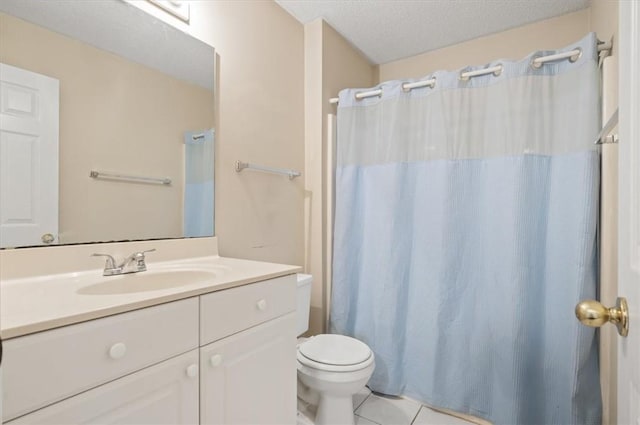 bathroom featuring vanity, a textured ceiling, tile patterned floors, and toilet