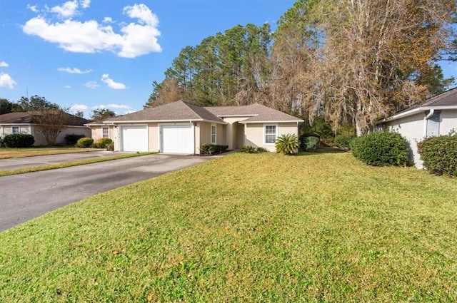 single story home with a garage and a front lawn