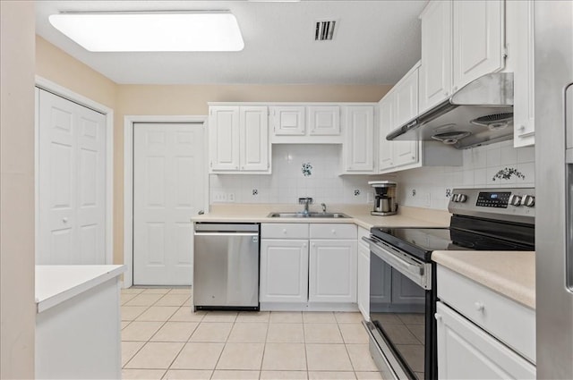 kitchen featuring decorative backsplash, stainless steel appliances, white cabinetry, and sink