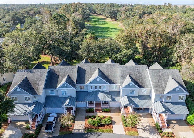 birds eye view of property featuring a view of trees