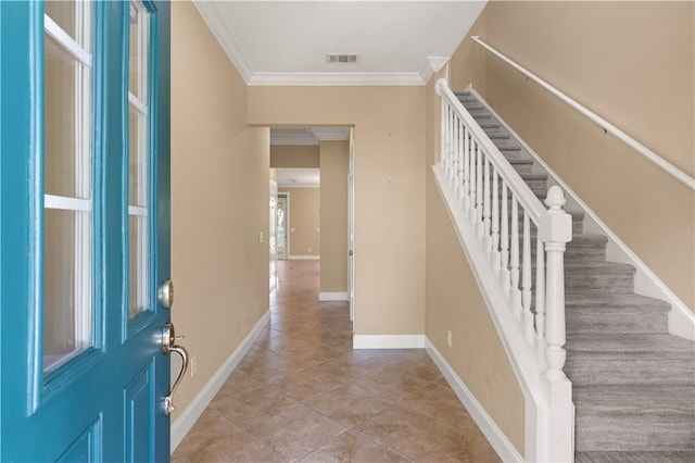 entryway with light tile patterned floors, visible vents, baseboards, stairs, and crown molding