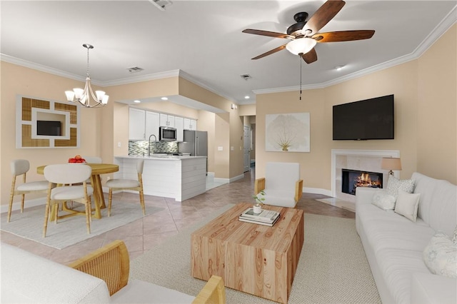 living room with baseboards, visible vents, ornamental molding, and a high end fireplace