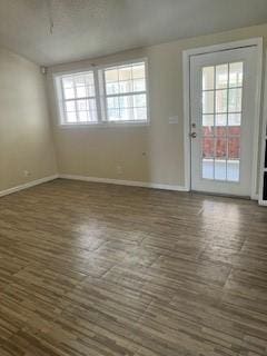 interior space with baseboards and dark wood-style floors