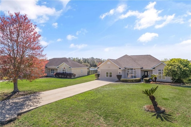 view of front facade with stucco siding, driveway, and a front lawn