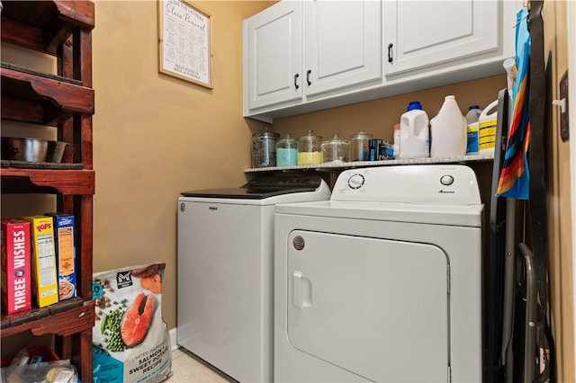 clothes washing area with cabinet space, light tile patterned floors, and independent washer and dryer