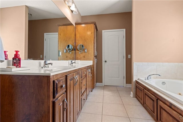 bathroom with baseboards, double vanity, a bath, tile patterned floors, and a sink