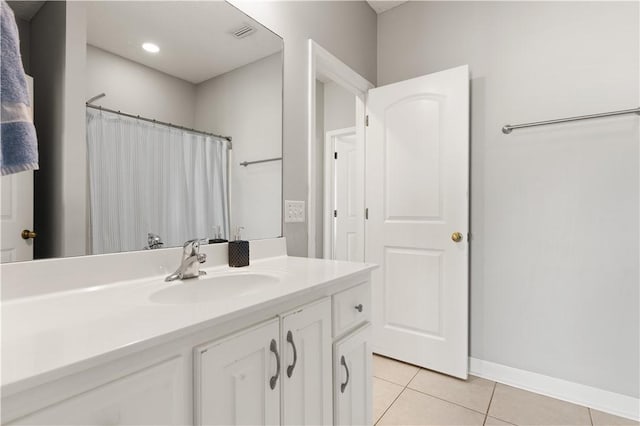 bathroom featuring tile patterned floors, visible vents, curtained shower, baseboards, and vanity