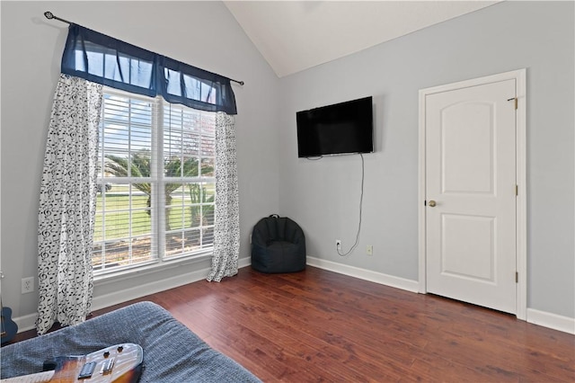 sitting room featuring baseboards, lofted ceiling, and wood finished floors