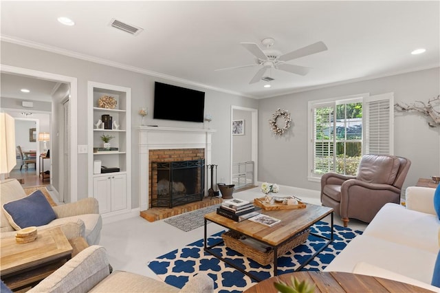 living room with ceiling fan, built in features, ornamental molding, and a fireplace