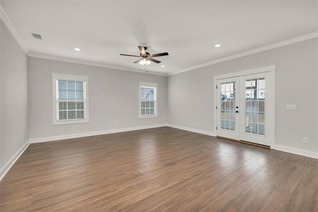 spare room with ornamental molding, dark hardwood / wood-style floors, ceiling fan, and french doors