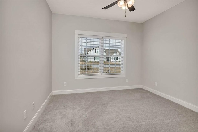 spare room featuring ceiling fan and light carpet