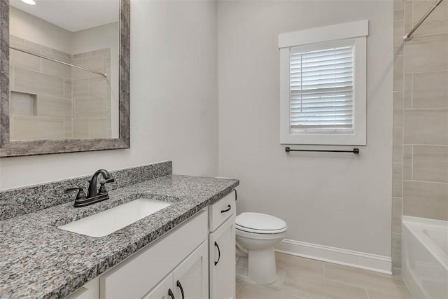 full bathroom featuring vanity, tiled shower / bath combo, and toilet