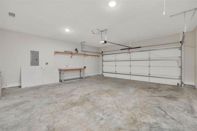 garage featuring a garage door opener and electric panel