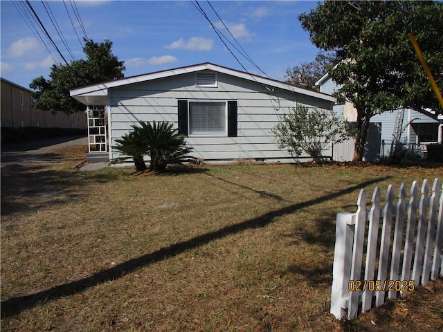 view of home's exterior with a lawn