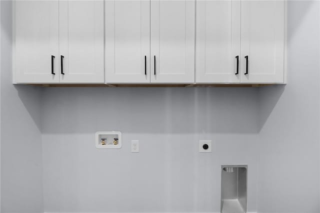 washroom featuring cabinet space, hookup for an electric dryer, and hookup for a washing machine
